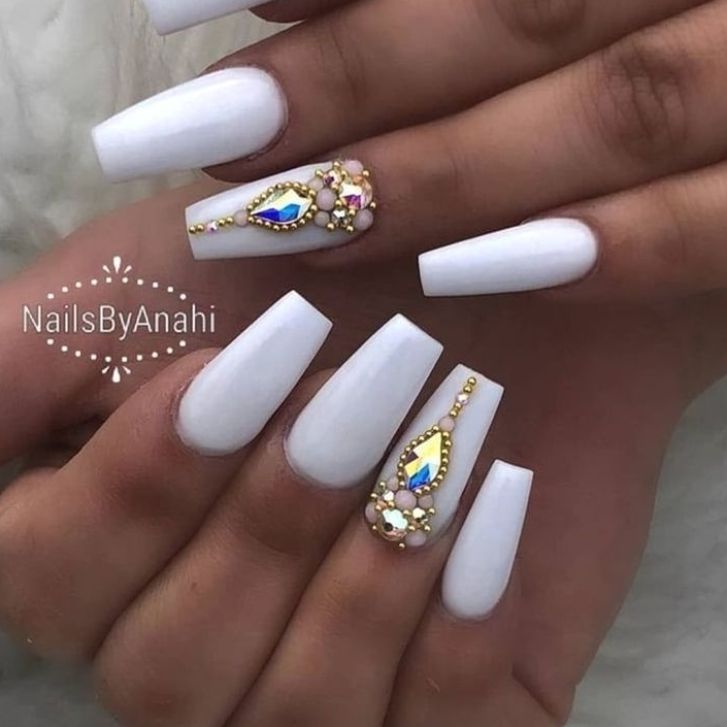 Sophisticated White Acrylic Manicure with Intricate Gem Accents for Glamorous Occasions.