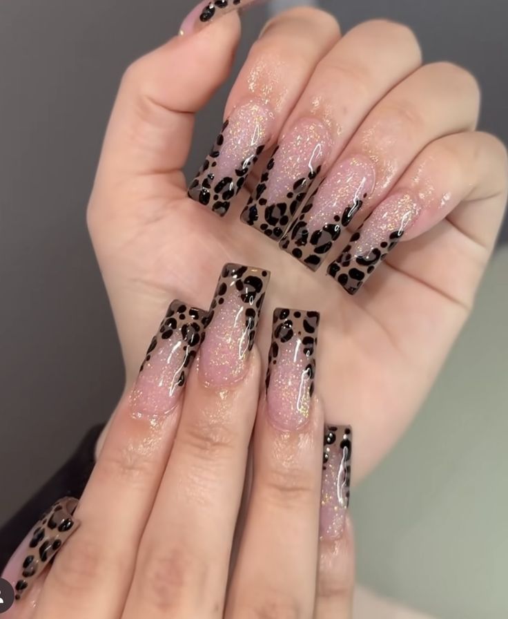 Chic Leopard Print Nail Design with Glossy Long Tips and Sophisticated Swirl Details.