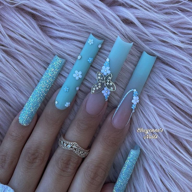 Elegant Pastel Blue Floral Nail Art with Glitter and Butterfly Accents.