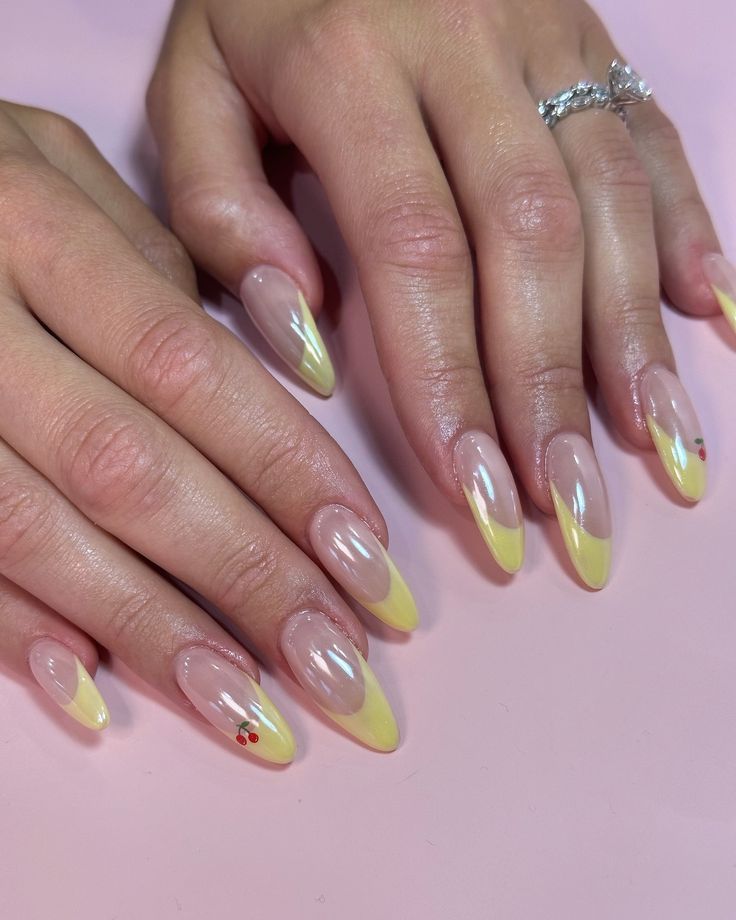 Chic Almond-Shaped Nails with Soft Yellow French Tips and Playful Cherry Accents