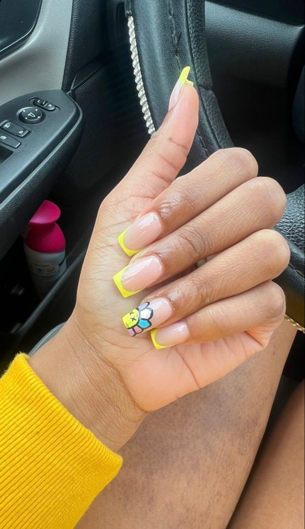 Vibrant Nail Design: Neon Yellow Tips and Whimsical Flower Accent for a Cheerful Statement Look.