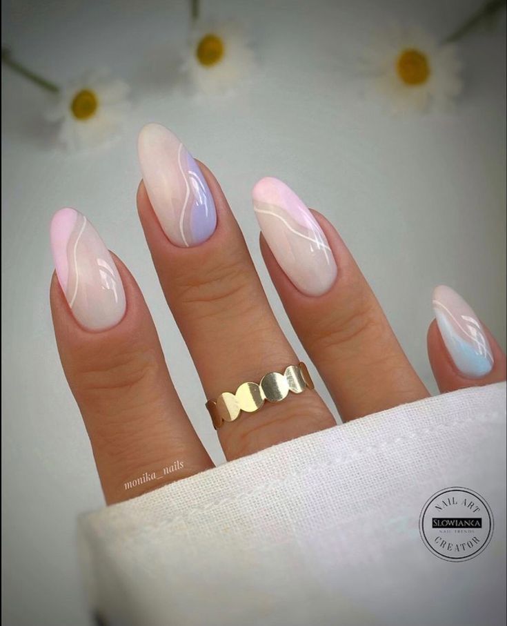 Elegant Pastel Ombre Nail Design with Delicate Swirls and Gold Ring Accents.