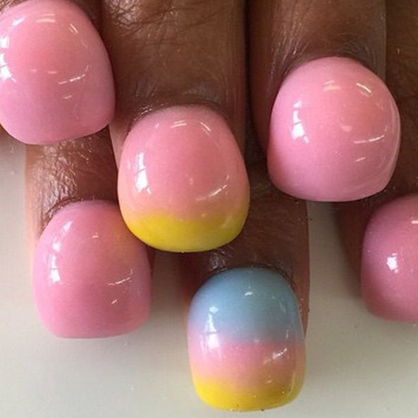 Pastel Ombre Nail Design: A Cheerful Blend of Pink, Yellow, and Blue for Spring Elegance.