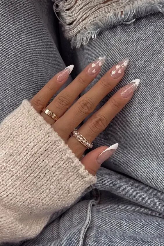 Chic Romantic Nail Design: Soft Pink and White French Tips with Heart Patterns