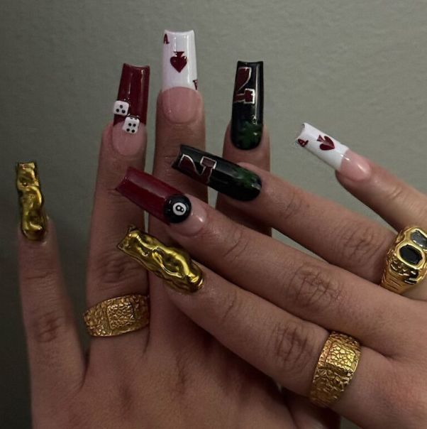 Vibrant Poker-Themed Nail Art with Bold Colors and Luxurious Golden Accents