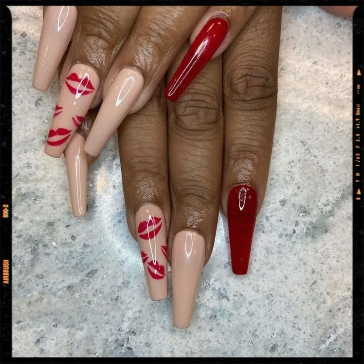 Sophisticated Nail Design: A Chic Fusion of Nude and Bold Red with Playful Lip Prints.