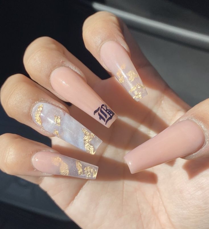 Sophisticated Nail Design: Elegant Beige and Translucent Marble Patterns with Gold Accents