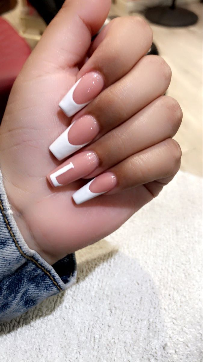 Chic French Tip Nail Design: Soft Pink and Striking White with Glossy Finish.