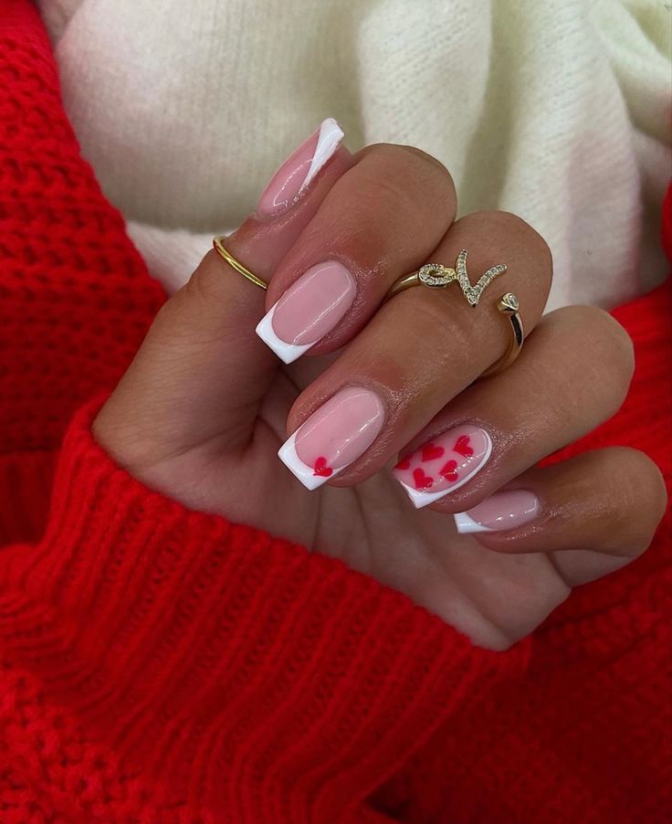 Chic French Tip Nail Design with Delicate Red Heart Accents for Romantic Occasions