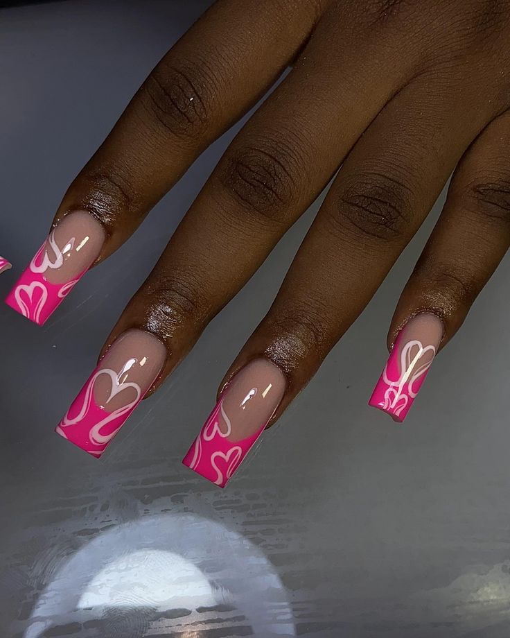 Glossy Pink Nails with Playful White Heart Patterns for a Fun, Romantic Look.