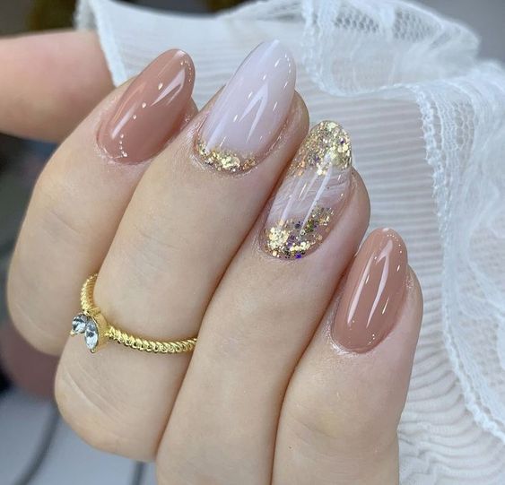 Chic Nail Design: Soft Nude and Pale Pink with Gold Glitter Accents