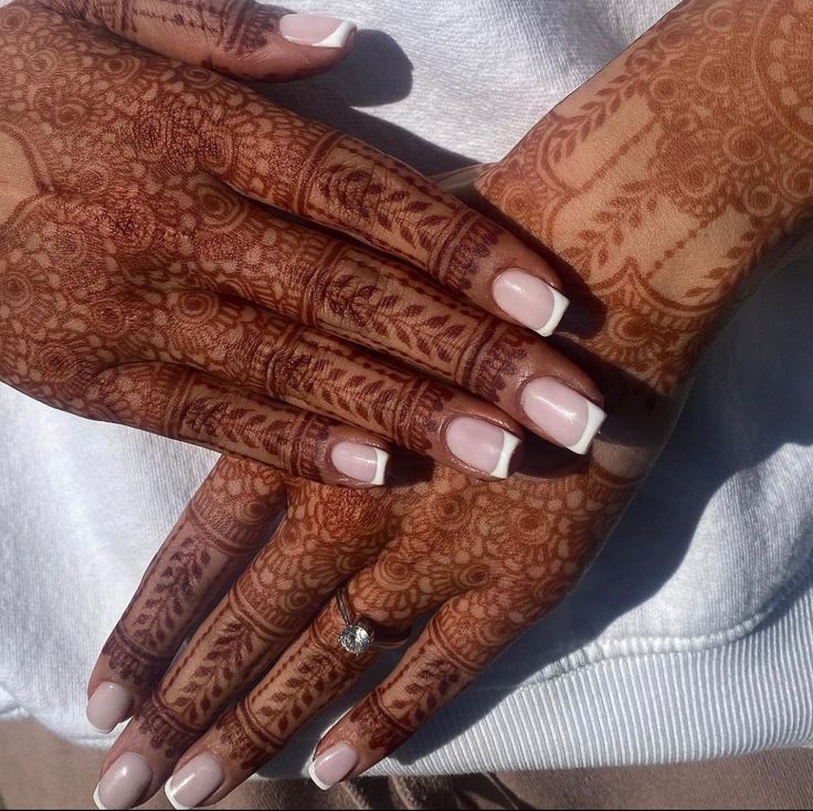 Elegant Fusion: Classic French Manicure Meets Intricate Henna Artistry.