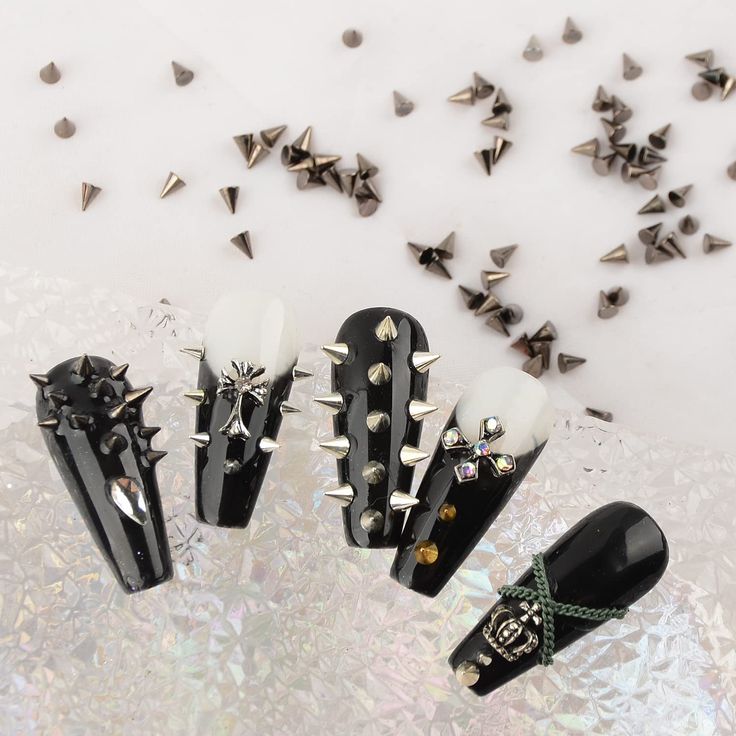 Edgy Sophistication: Bold Nail Design with Metallic Spikes and Gems