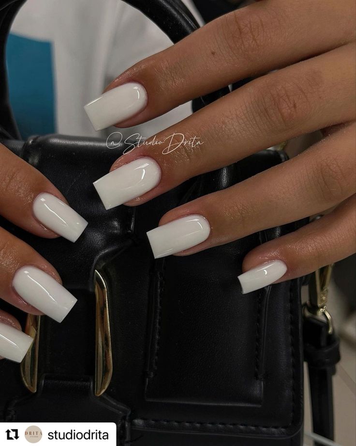 Modern Elegance: Sleek White Acrylic Nails Paired with a Chic Black Handbag.