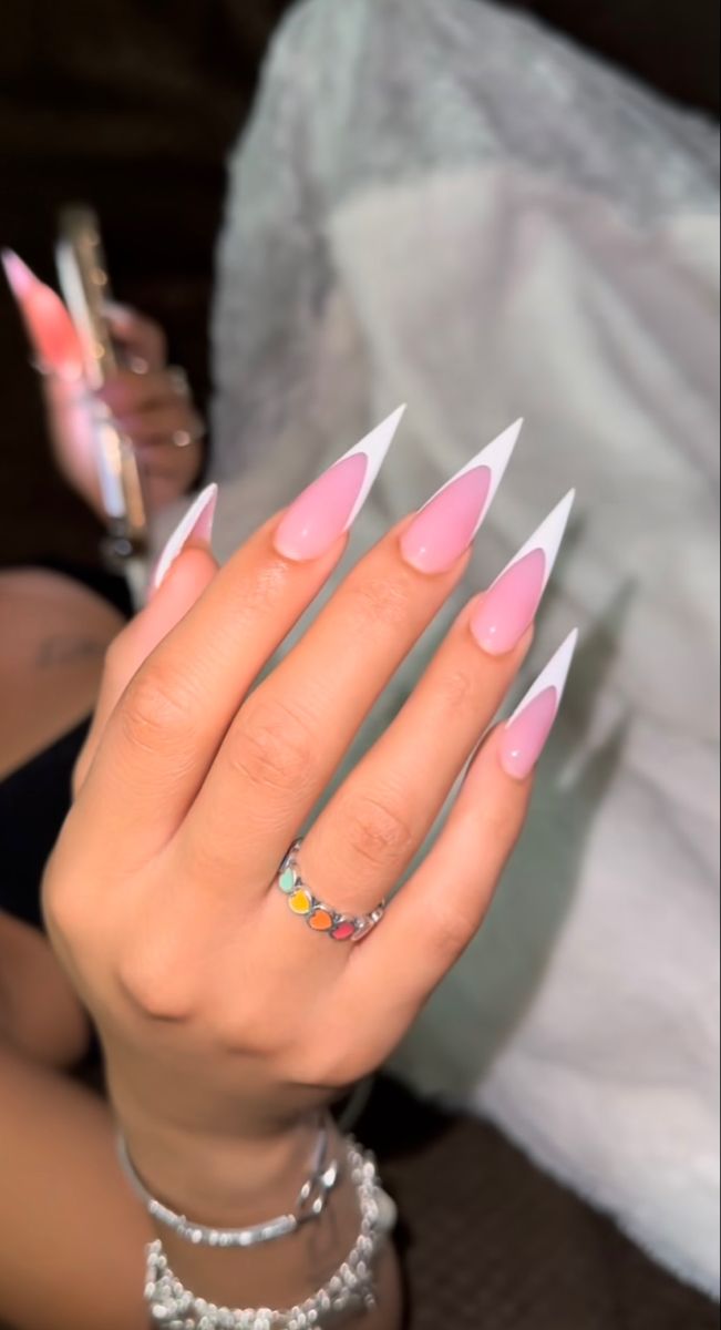 Chic Long Stiletto Nails: Soft Pink with White Tips for a Trendy Statement Look.