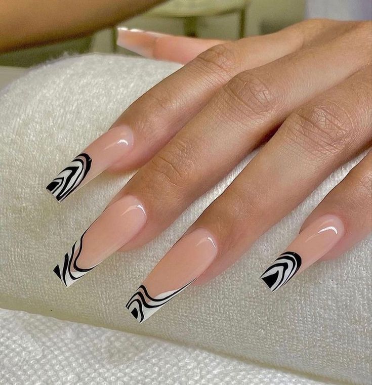 Sophisticated Long Acrylic Nail Design with Bold Black and White Swirls on a Nude Base.