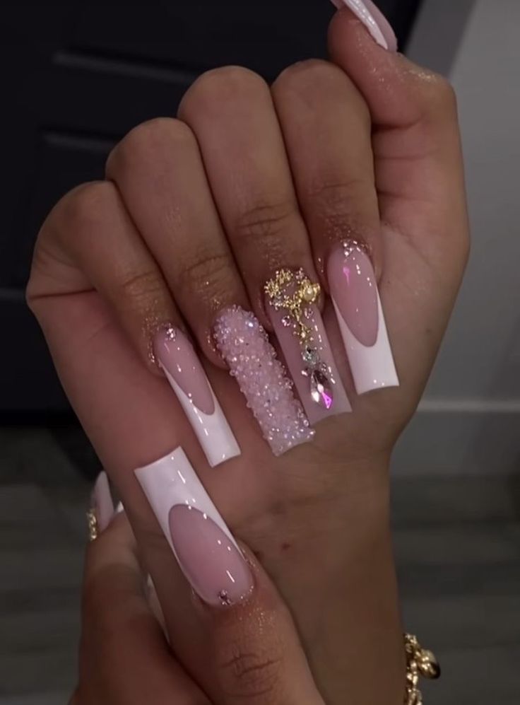 Sophisticated Nail Design: Glossy White and Soft Pink with Textured Accents and Sparkling Embellishments.