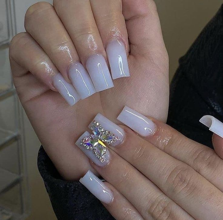 Chic Ombre Nail Design with Sparkling Butterfly Accents.