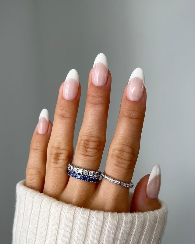 Chic Contemporary French Manicure with Gemstone-Accented Rings for Versatile Elegance.