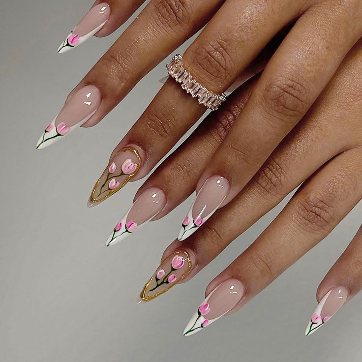 Chic Nude Nail Design with Pointed Tips, Pink Floral Accents, and Geometric Lines.