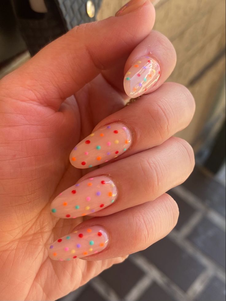 Playful Peachy Nail Design with Colorful Polka Dots