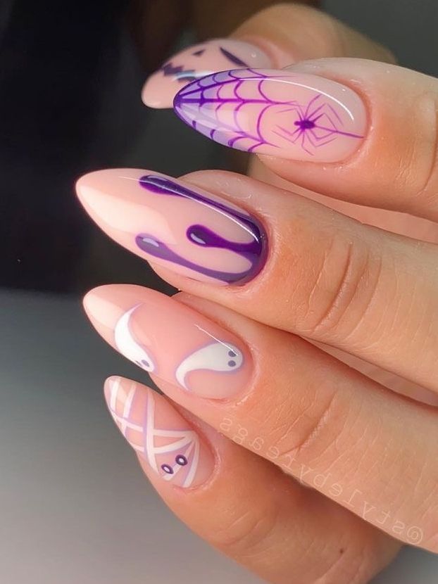 Eye-Catching Nail Design: Soft Nude and Vibrant Purple with Intricate Patterns and Playful Accents.