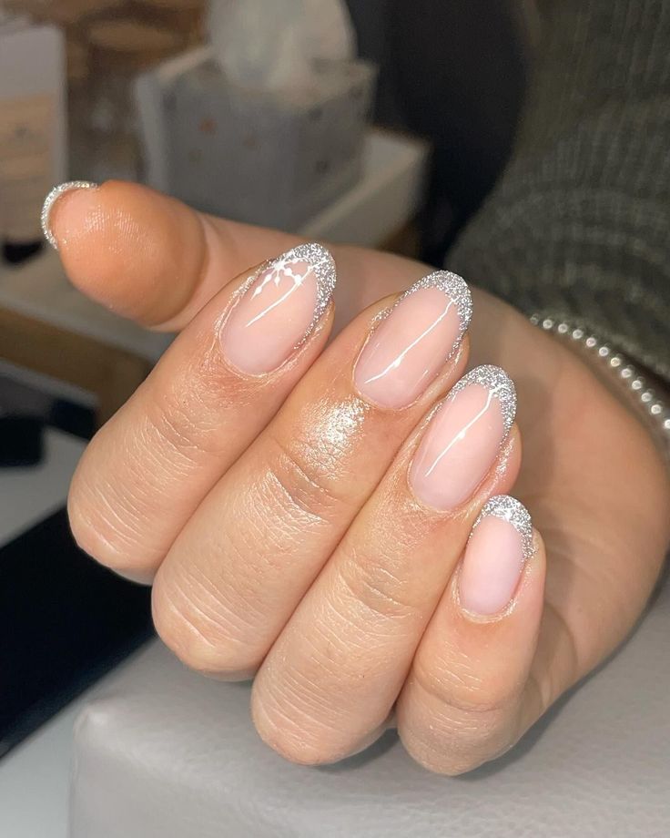 Sophisticated Nail Design: Translucent Base with Delicate Silver Glitter French Tip