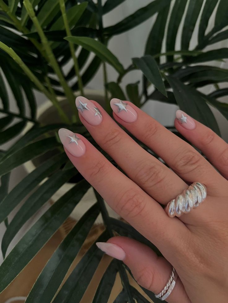 Whimsical Chic: Soft Pink Nails with Delicate White French Tips and Silver Star Accents