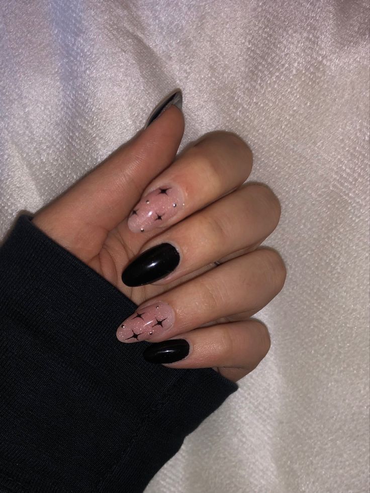 Elegant Black and Nude Nail Design with Whimsical Star Patterns