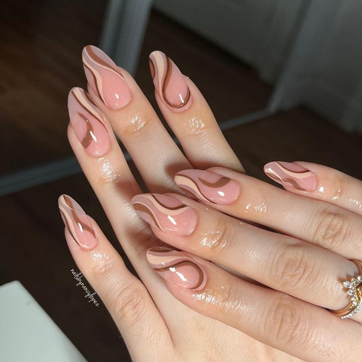 Elegant Fluid Wave Patterns: Stunning Marbled Nude and Soft Brown Nails with Glossy Finish.