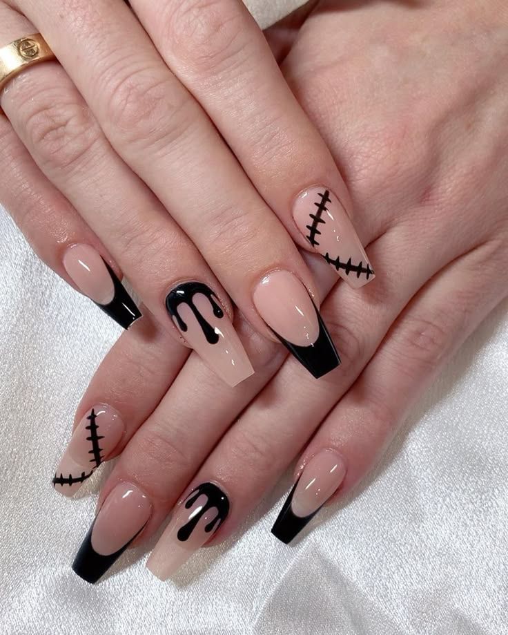 Edgy Nail Design: Striking Contrast of Nude and Black with Intricate Stitched Patterns.