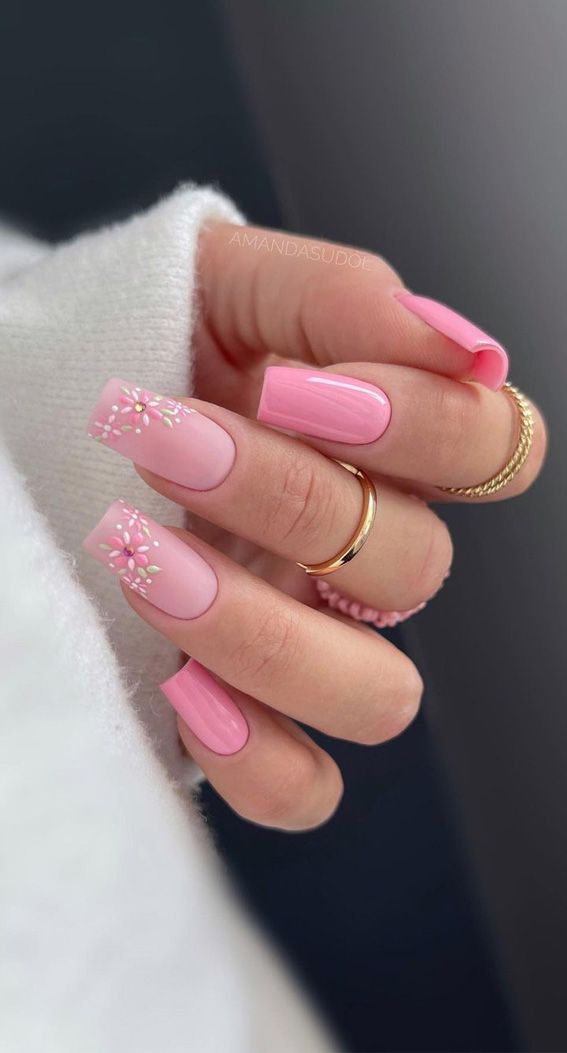 Chic Floral Pink Nail Design Paired with Understated Gold Rings for Effortless Elegance.