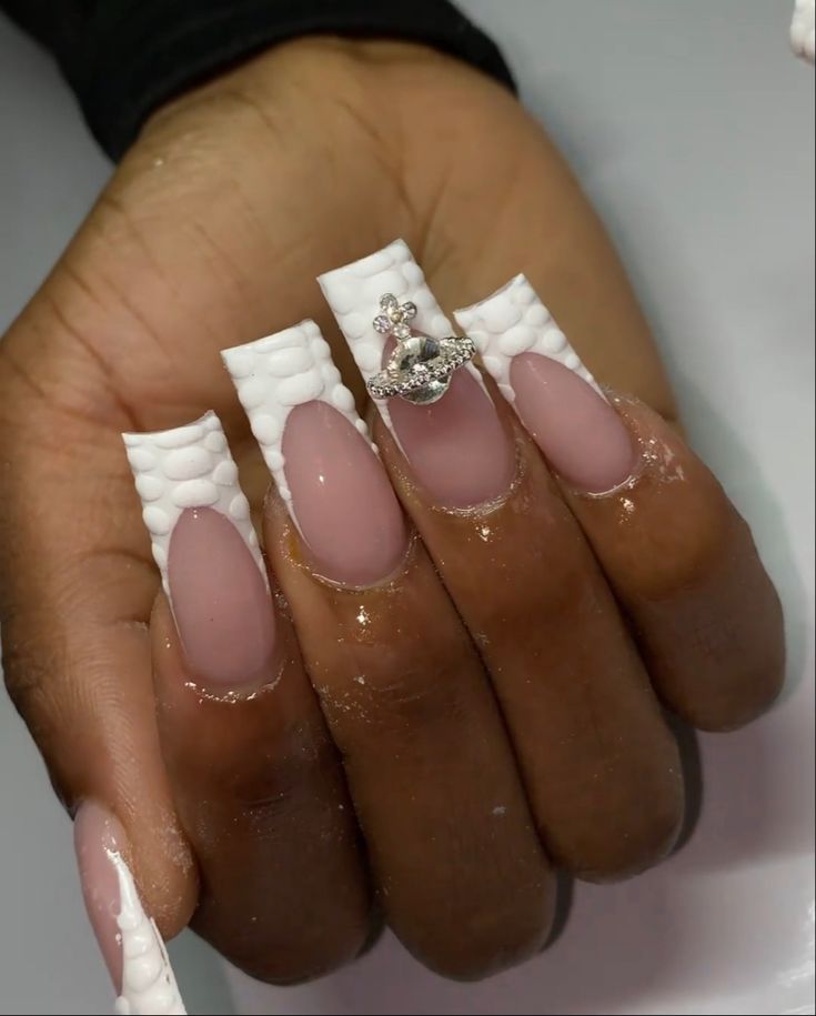 Chic Nail Design with Soft Nude and Textured White Accents, Featuring Glossy Finish and Decorative Gem.