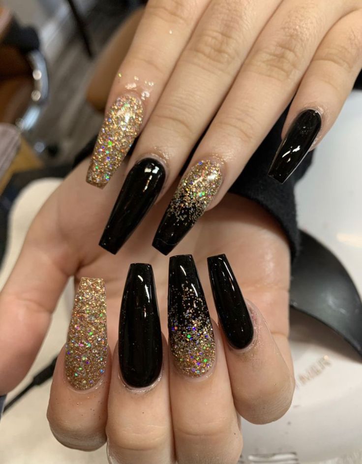 Glamorous Black and Gold Glittering Nail Design for Elevated Elegance.