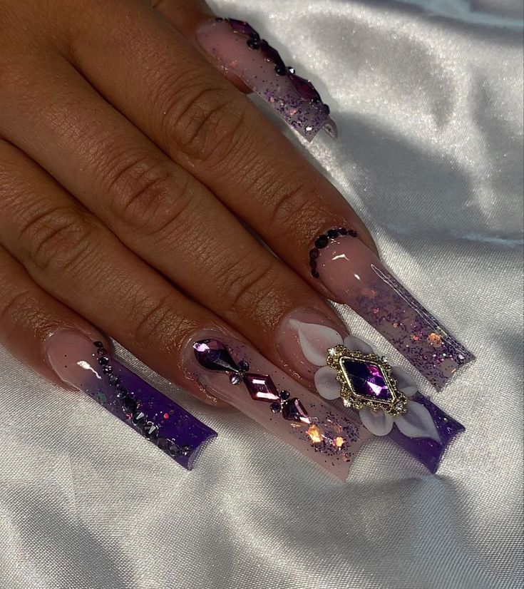 Elegant Nail Design: Soft Nude and Vibrant Purple with Glitter, Gems, and Floral Accents