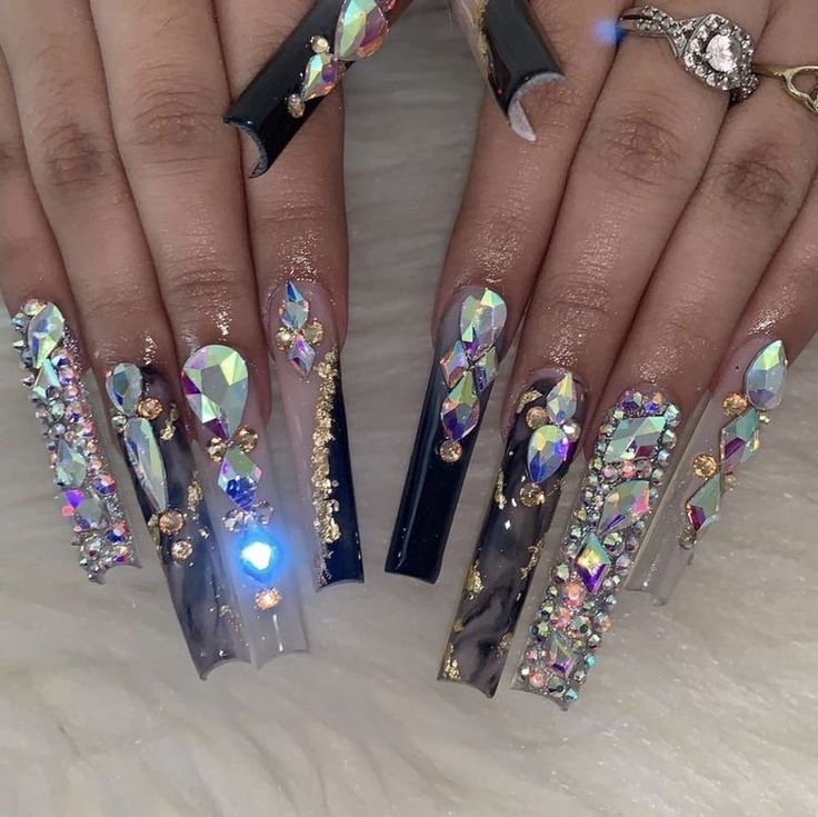 Luxurious Nail Design with Elongated Tips, Sparkling Crystals, and Striking Color Contrast.