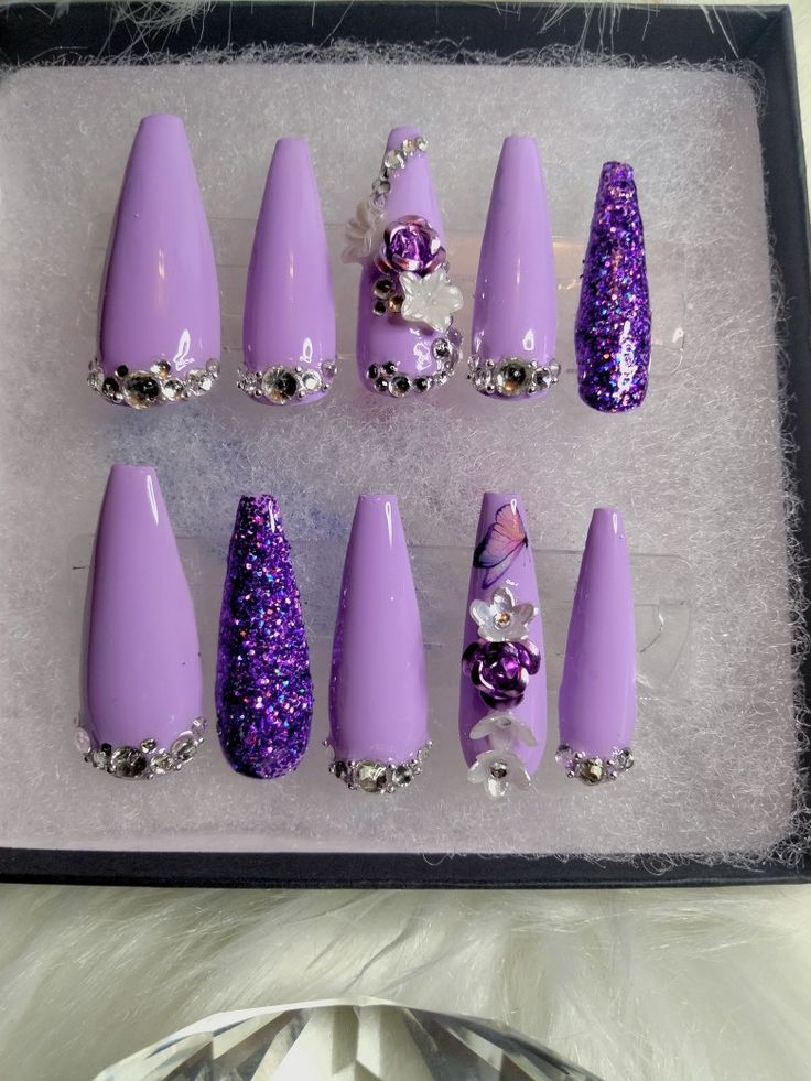 Chic Lavender Nail Design with Glossy Finishes and Floral Accents.