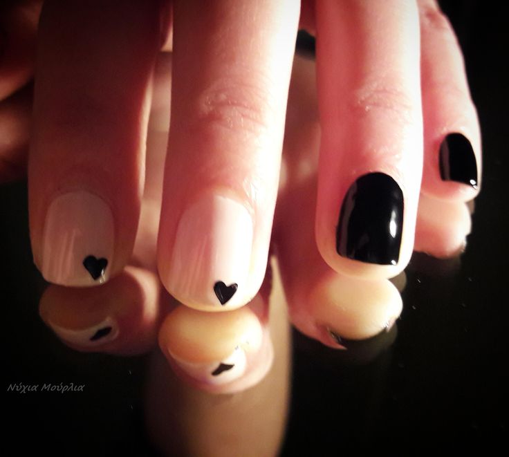 Chic Nail Design: Whimsical Heart Motif in Soft Beige and Deep Black.