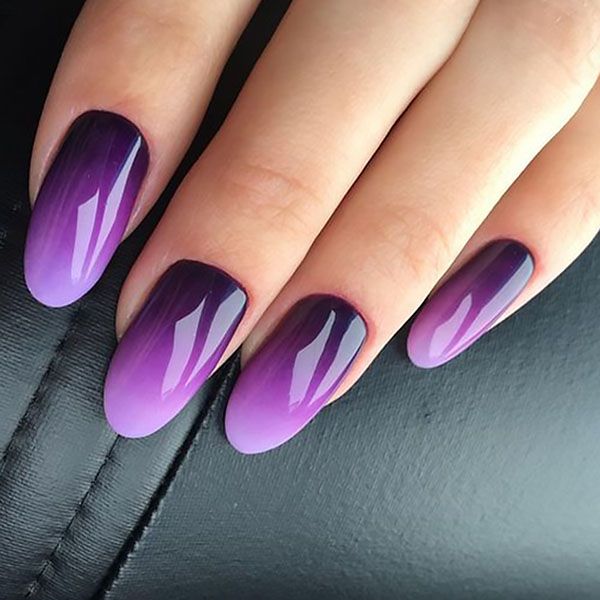 Elegant Ombre Nail Design: Deep Purple to Lilac Gradient on Almond-Shaped Nails.