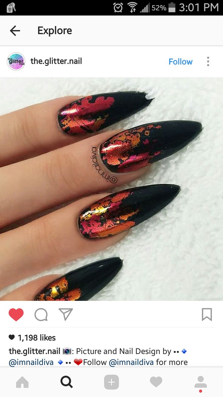 Dramatic Nail Art: Glossy Black Base with Fiery Metallic Accents