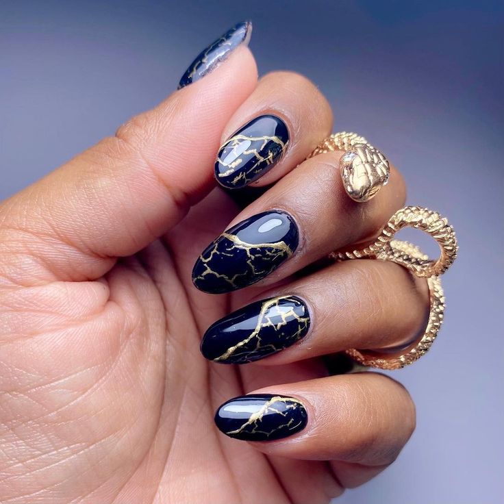 Chic Navy Blue and Gold Foil Nail Design: A Sophisticated Fusion of Glossy and Matte Finishes.