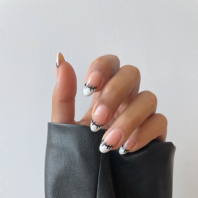 Edgy Classic French Tips: Bold Black Stitching for a Playful Sophistication.