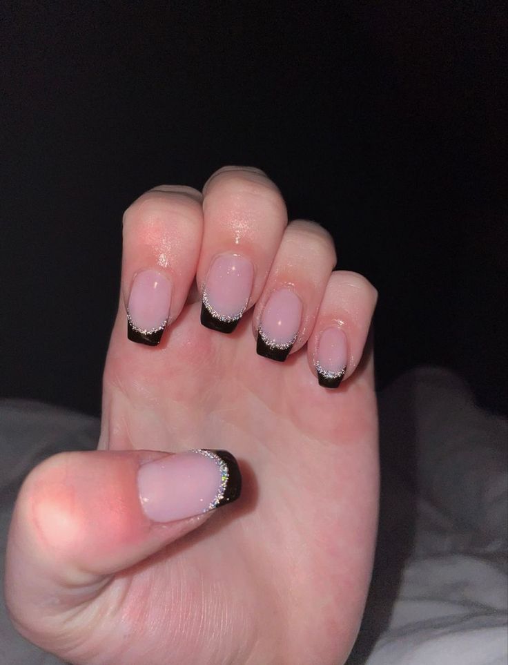 Sophisticated Translucent Pink and Black Tip Nail Design with Delicate Silver Accents.