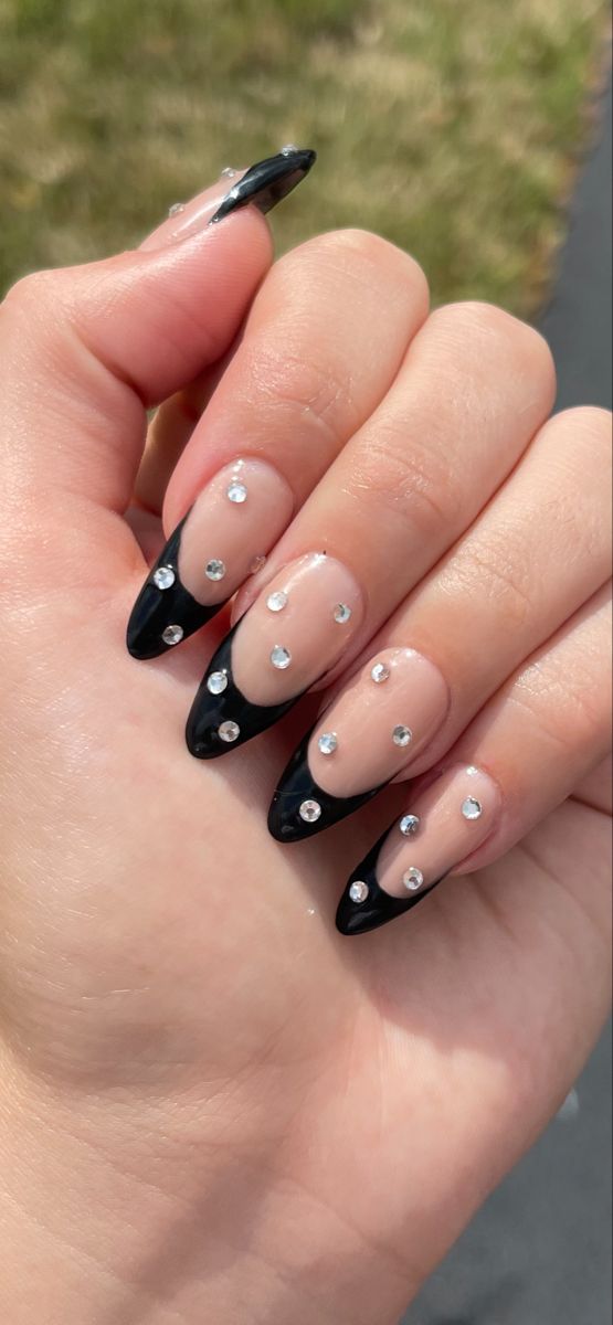 Elegant Black Tip Nails with Clear Polish and Glamorous Rhinestone Accents.