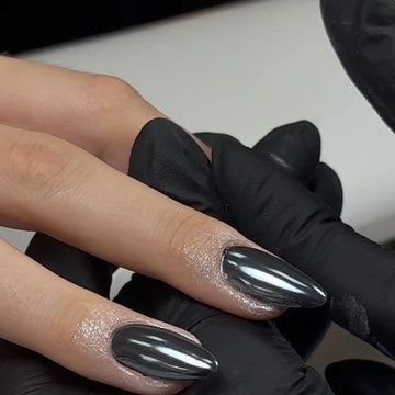 Striking Charcoal Gray Stiletto Nails with Shimmering Silver Gradient for a Glamorous Look.