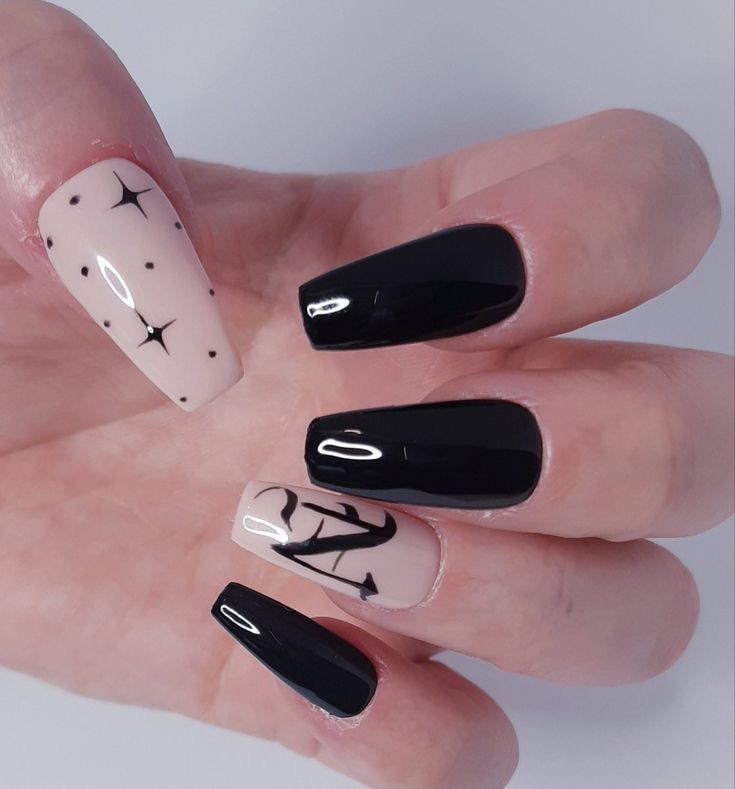 Chic Black and Nude Nail Design with Geometric Patterns and Glamorous Accents.