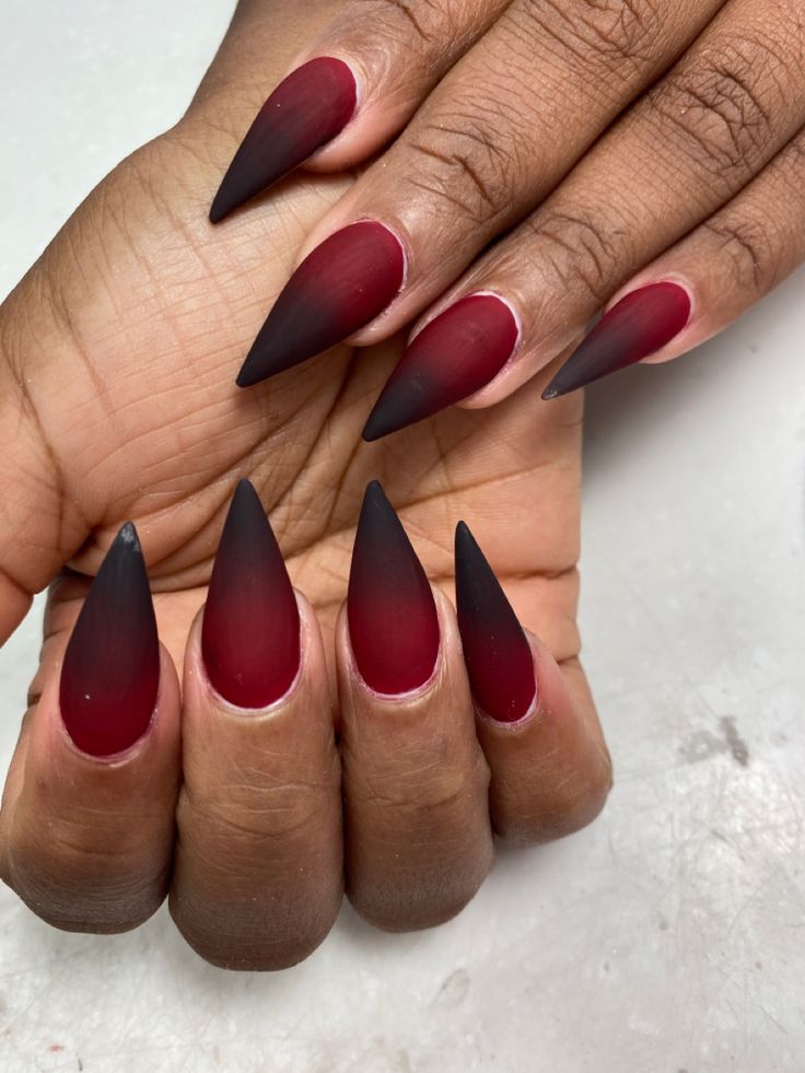 Bold Gradient Long Stiletto Nails in Burgundy to Black with Edgy Matte Finish.