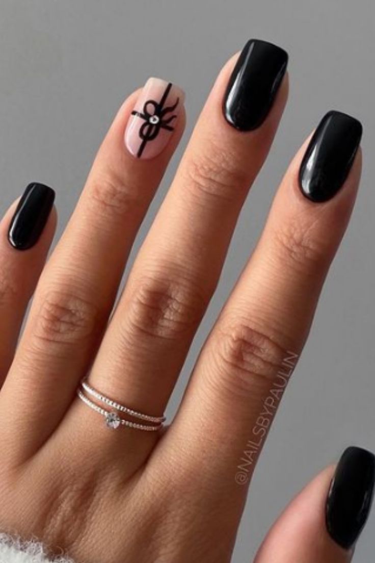 Chic Autumn Nail Design: Glossy Black and Soft Pink with Whimsical Spider Illustration.