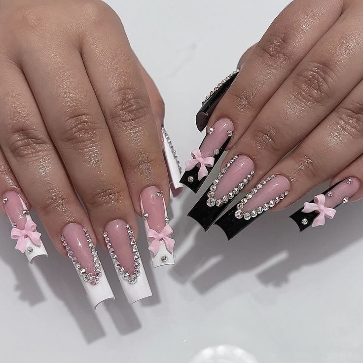 Chic Pink, Black, and White Rhinestone-Embellished Nail Design with Playful Bows.