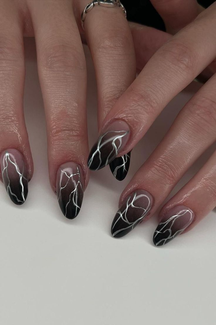 Dramatic Black and White Ombre Nail Design with Intricate Lightning Bolt Patterns